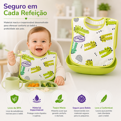Bebé feliz a comer com um babador impermeável, destacando a segurança e o conforto durante a refeição.