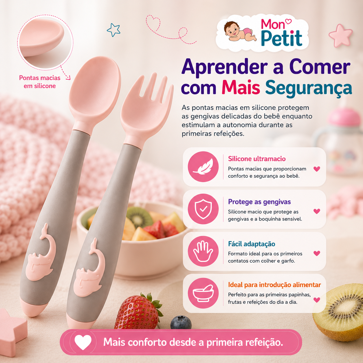 Grande plano da colher e do garfo de silicone para bebé ao lado de uma taça com fruta fresca, realçando o design seguro que protege as gengivas delicadas durante as primeiras papas.